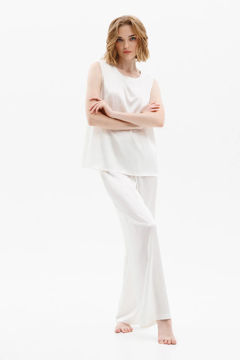 Woman wearing a white silk sleeveless top (sold separately) and white silk pants showing the front