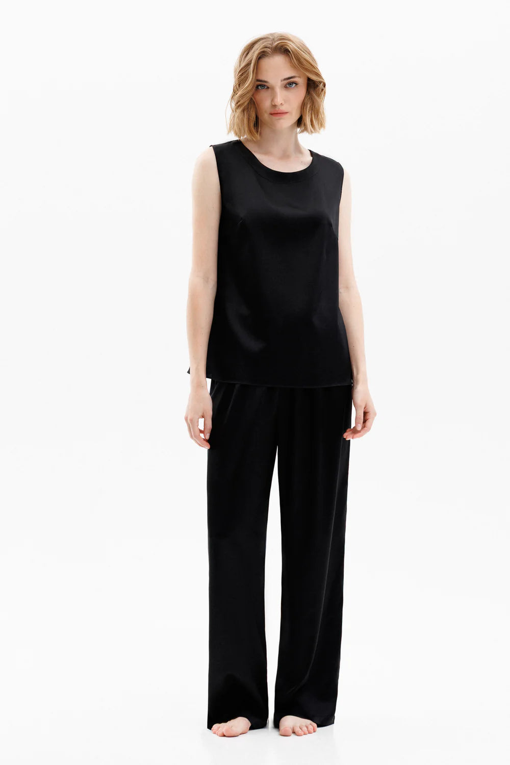 Woman wearing a black silk sleeveless top (sold separately) and black silk pants 