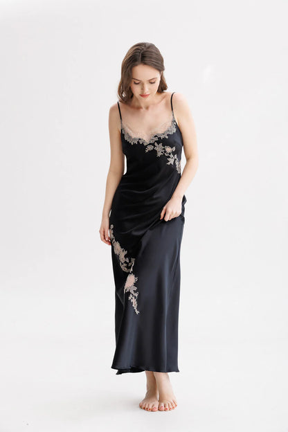 Woman wearing a black silk maxi slip dress with Leavers Lace details. Spaghetti strap stile 