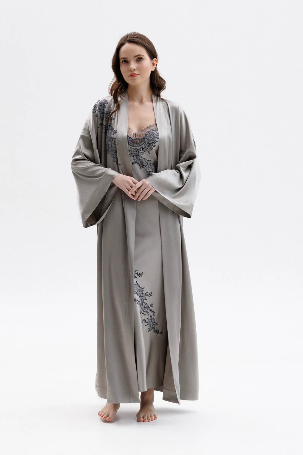 Woman wearing a long classy silk kimono stile dressing gown with matching elegant silk nightdress with floral embroidery (sold separately). Full front picture.