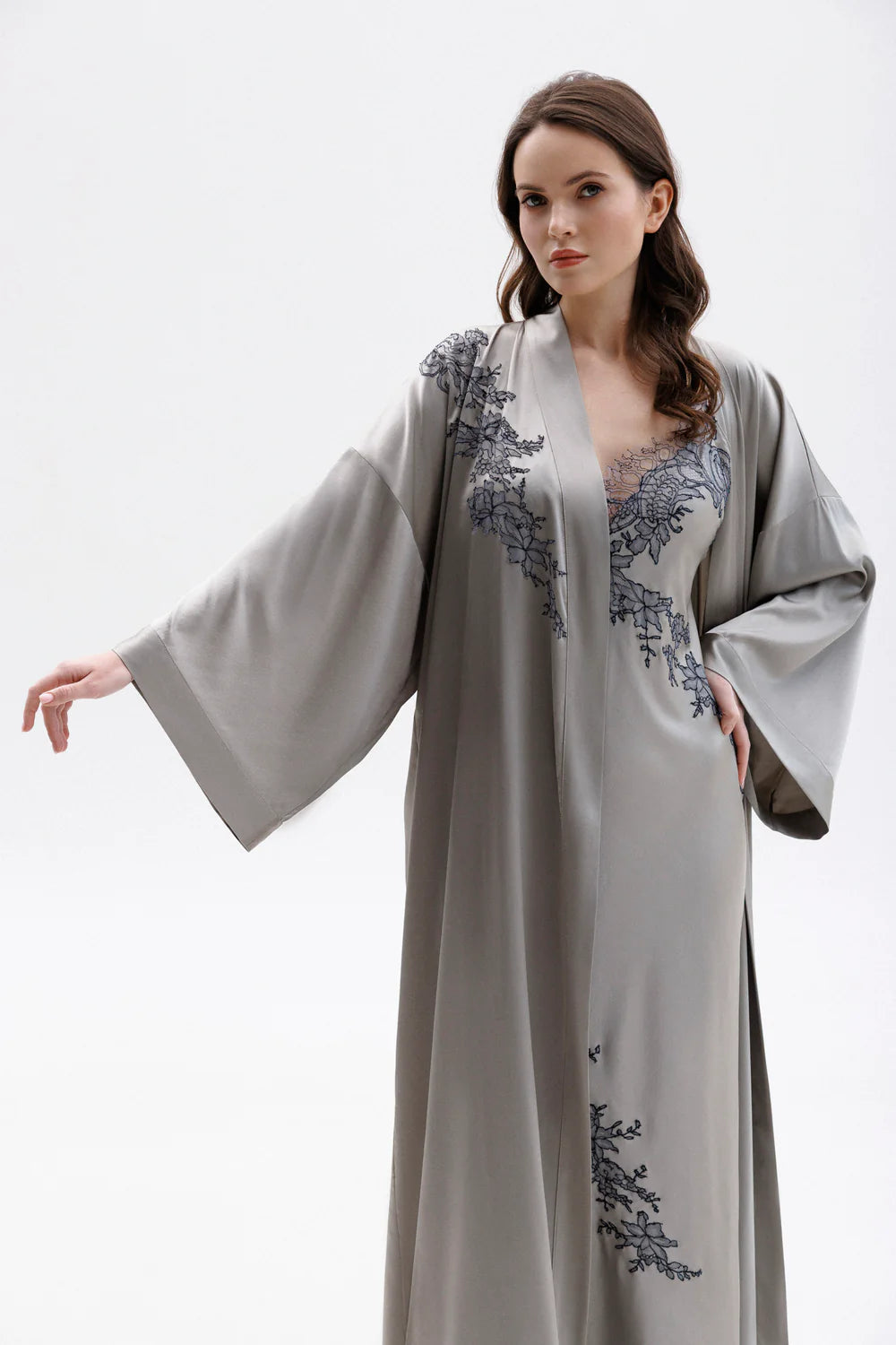 Woman wearing a gray silk nightgown with lace detailing (sold separately) and a matching elegant silk robe . Showing the elegancy of the sleave