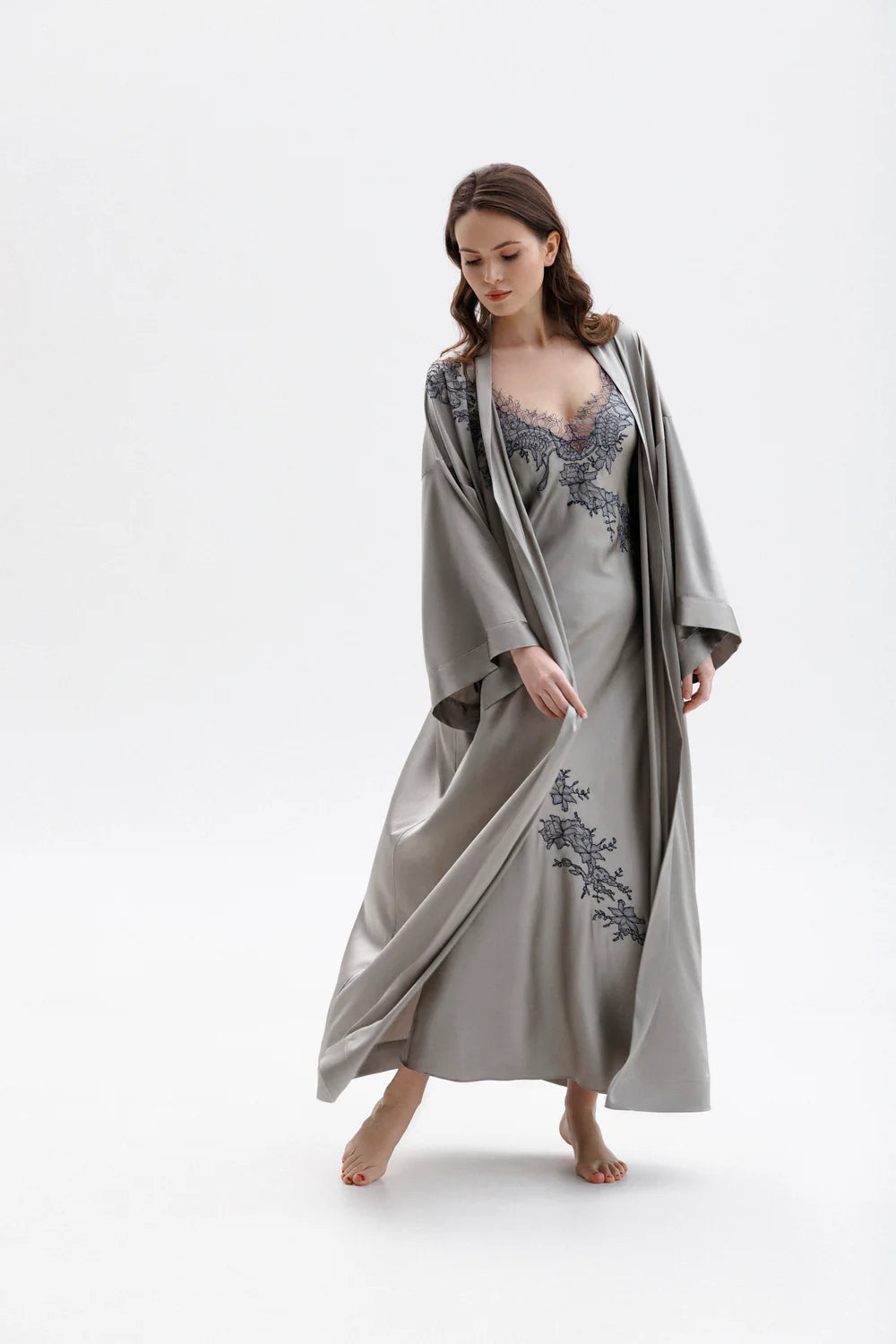 Woman wearing a long classy silk kimono stile dressing gown with matching elegant silk nightdress with floral embroidery (sold separately). Full front picture.