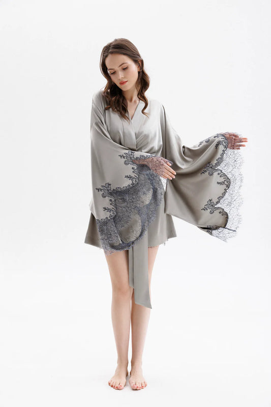 Woman wearing a gray silk robe with Leavers Lace sleeves showing the elegance of the sleaves