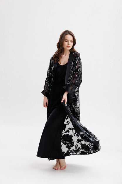 Woman wearing a black floral silk velvet kimono. Front full picture